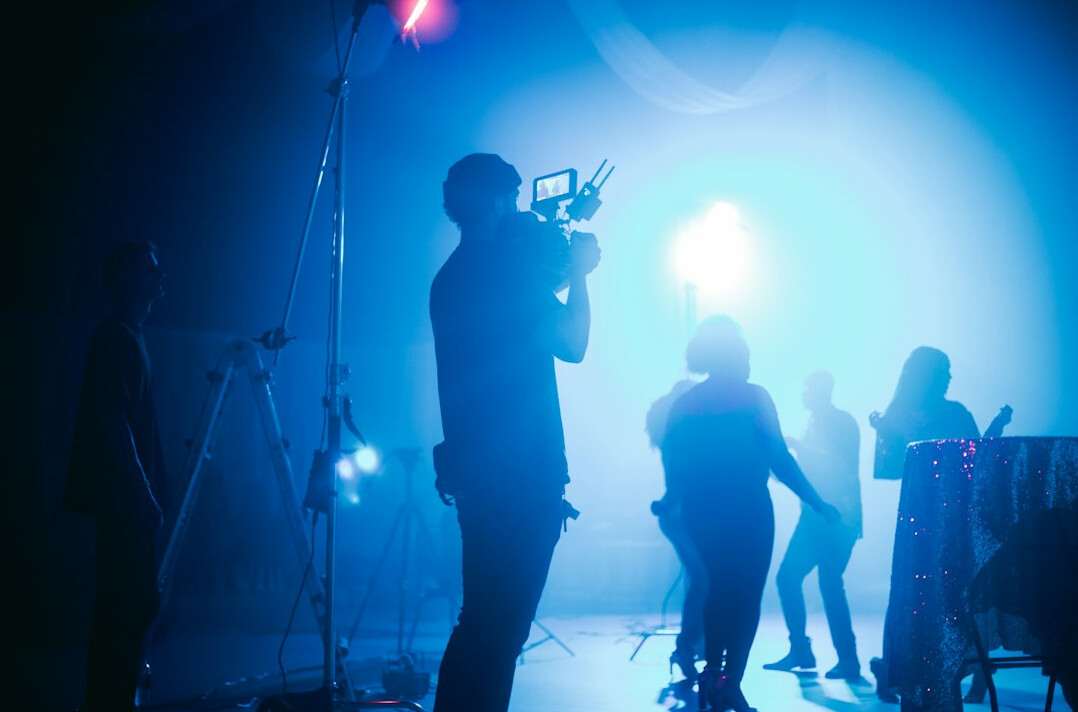 cinematographer adjusting lights on set