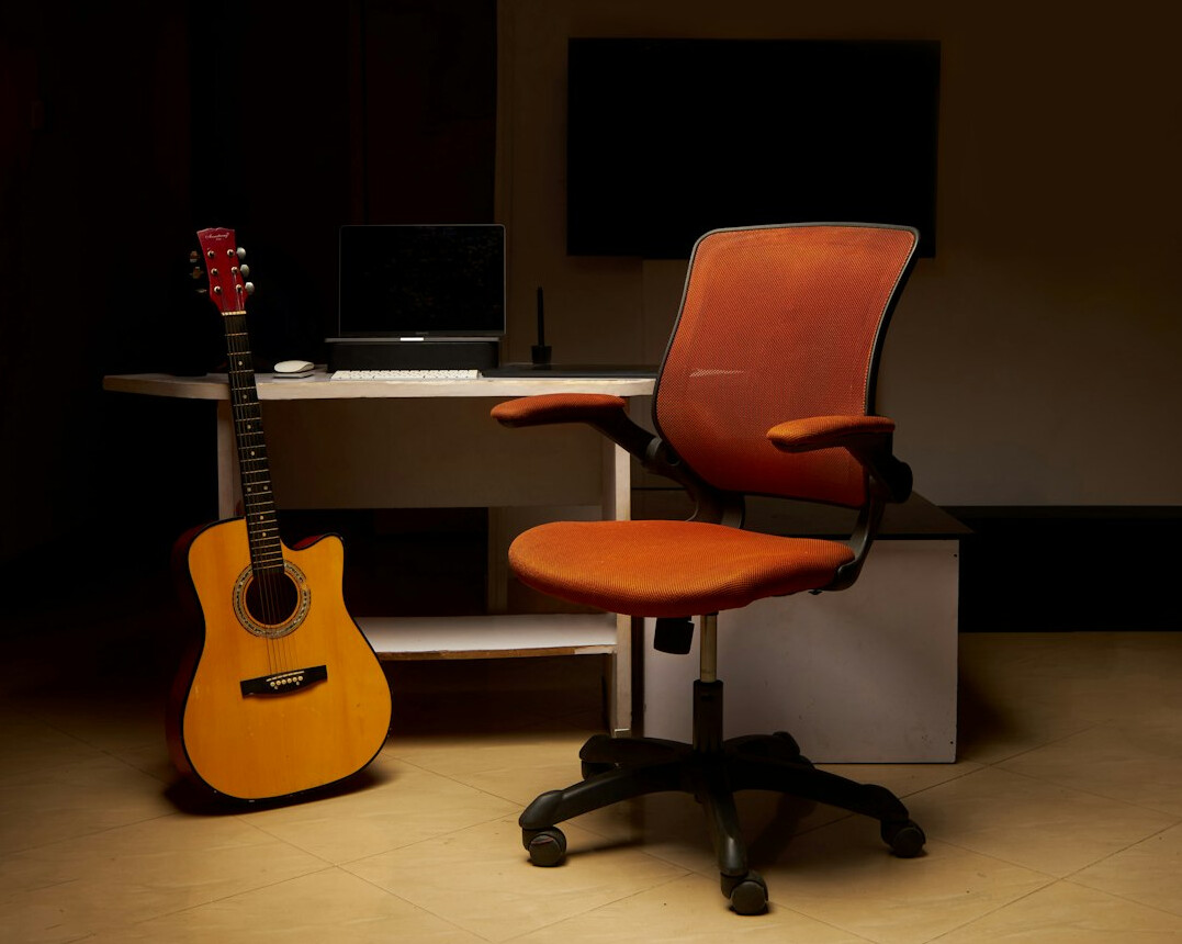 Bright creative studio office with desks and camera equipment on shelves