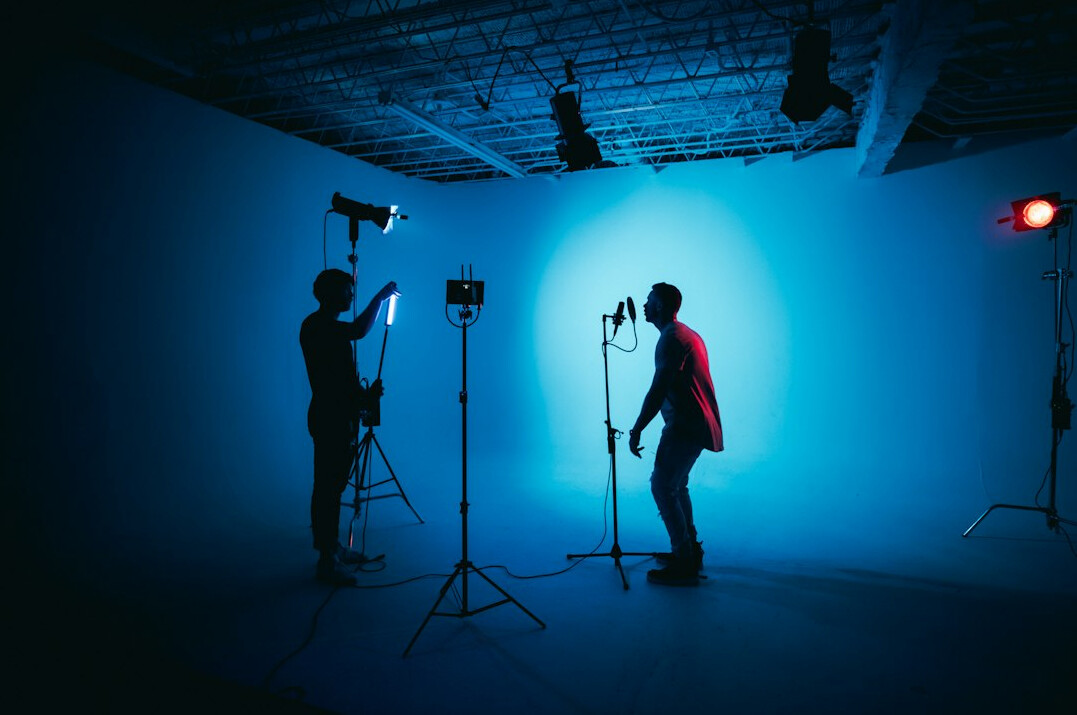 cinematographer adjusting lights on set